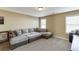 Bonus room with large sectional sofa and natural lighting at 2225 Independence Ln, Buford, GA 30519