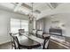 Bright dining room showcasing a coffered ceiling, hardwood floors, and elegant decor at 2225 Independence Ln, Buford, GA 30519