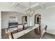 Elegant dining room with coffered ceilings, hardwood floors, and a statement chandelier at 2225 Independence Ln, Buford, GA 30519