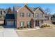 Charming two-story brick home with attached garage and a well-manicured front lawn at 2225 Independence Ln, Buford, GA 30519