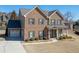 Traditional two-story brick home featuring manicured landscaping and a well-maintained front lawn at 2225 Independence Ln, Buford, GA 30519