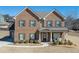 Charming two-story brick home with a welcoming front porch and well-maintained landscaping at 2225 Independence Ln, Buford, GA 30519