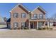 Charming two-story brick home with manicured landscaping, covered front porch and a well-maintained lawn at 2225 Independence Ln, Buford, GA 30519