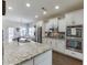 Modern kitchen featuring granite countertops, stainless steel appliances, and stylish backsplash at 2225 Independence Ln, Buford, GA 30519