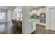 Open concept kitchen has white cabinets, stainless appliances, granite counters, and bar seating at 2225 Independence Ln, Buford, GA 30519