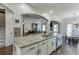 Bright kitchen features granite countertops, stainless steel appliances, and open access to the living room at 2225 Independence Ln, Buford, GA 30519