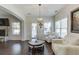 Sunlit living room with hardwood floors, stone fireplace, and comfortable seating at 2225 Independence Ln, Buford, GA 30519