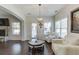 Comfortable living room featuring a fireplace, large windows, and hardwood floors at 2225 Independence Ln, Buford, GA 30519