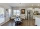 Bright living room with large windows, hardwood floors, and access to the kitchen at 2225 Independence Ln, Buford, GA 30519