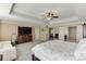 Spacious main bedroom features a trey ceiling, ceiling fan, and sitting area at 2225 Independence Ln, Buford, GA 30519