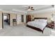 Main bedroom with tray ceiling, ceiling fan, and adjacent office through doorway at 2225 Independence Ln, Buford, GA 30519