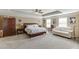Large main bedroom with tray ceiling, seating area, and multiple windows with light at 2225 Independence Ln, Buford, GA 30519