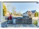 Outdoor kitchen with stainless steel appliances and a built-in grill, perfect for outdoor cooking and entertaining at 2225 Independence Ln, Buford, GA 30519