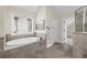 Bright bathroom featuring a soaking tub and a glass shower at 2740 Cezanne Ln, Cumming, GA 30041