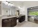 Luxurious bathroom with dual sinks, granite countertops, and a view of the main bedroom at 2740 Cezanne Ln, Cumming, GA 30041