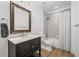 Bright bathroom featuring a vanity with dark cabinets and a shower-tub combo at 2740 Cezanne Ln, Cumming, GA 30041