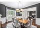 Elegant dining room with modern lighting, wainscoting, and views to the front yard and office at 2740 Cezanne Ln, Cumming, GA 30041