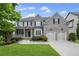 Beautiful two-story home with a well-manicured lawn, brick facade, and a two-car garage at 2740 Cezanne Ln, Cumming, GA 30041