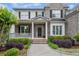 Charming home entrance with a covered porch, brick walkway, and lush landscaping at 2740 Cezanne Ln, Cumming, GA 30041