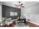 Stylish home office featuring a dark accent wall, hardwood floors, and a comfortable chair at 2740 Cezanne Ln, Cumming, GA 30041