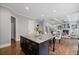 Open kitchen featuring a large island with granite countertops, hardwood floors, and modern lighting at 2740 Cezanne Ln, Cumming, GA 30041