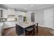 Modern kitchen with white cabinets, granite countertops, and a center island with seating at 2740 Cezanne Ln, Cumming, GA 30041