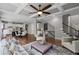 Open-concept living room with a view to the kitchen, hardwood floors, and coffered ceiling at 2740 Cezanne Ln, Cumming, GA 30041