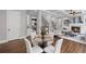 Elegant dining area and living room boasts hardwood floors, a fireplace, and coffered ceilings at 2740 Cezanne Ln, Cumming, GA 30041