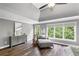 Bright main bedroom with hardwood floors, a chaise lounge and natural light at 2740 Cezanne Ln, Cumming, GA 30041
