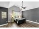 Spacious bedroom with a ceiling fan, hardwood floors, and natural light from the window at 2740 Cezanne Ln, Cumming, GA 30041