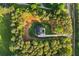 Aerial view of the home nestled amongst trees, featuring a circular driveway and serene surroundings at 400 Auburn Rd, Auburn, GA 30011