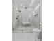 Modern bathroom featuring marble tile and glass enclosed walk-in shower with bench at 400 Auburn Rd, Auburn, GA 30011