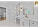 Luxurious bathroom with double vanities, marble countertops, gold fixtures, and a spacious walk-in closet at 400 Auburn Rd, Auburn, GA 30011