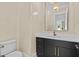 Elegant powder room featuring a black vanity with gold hardware, quartz countertop, and decorative lighting at 400 Auburn Rd, Auburn, GA 30011