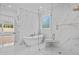 Bright bathroom with a glass shower, free-standing tub, and marble tile at 400 Auburn Rd, Auburn, GA 30011