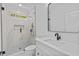 Modern bathroom featuring a glass shower with a marble tile surround, a toilet, and a sink at 400 Auburn Rd, Auburn, GA 30011