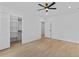 Spacious bedroom with a ceiling fan, hardwood floors, closet, and white walls at 400 Auburn Rd, Auburn, GA 30011