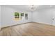 Bedroom features hardwood floors, a modern light fixture and large windows at 400 Auburn Rd, Auburn, GA 30011