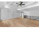 Bright bedroom features a ceiling fan, tray ceiling and hardwood floors at 400 Auburn Rd, Auburn, GA 30011