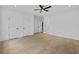 Open bedroom with recessed lighting, hardwood floors, multiple doors, and ceiling fan at 400 Auburn Rd, Auburn, GA 30011