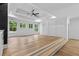 Sunlit bedroom features large windows, hardwood floors, and a tray ceiling with fan at 400 Auburn Rd, Auburn, GA 30011