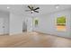 Bright bedroom with wood floors, closet, ceiling fan, and natural light through large windows at 400 Auburn Rd, Auburn, GA 30011