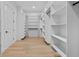 Spacious walk-in closet with custom shelving and hardwood floors at 400 Auburn Rd, Auburn, GA 30011