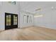 Open and bright dining area with hardwood floors, modern light fixture, and large windows at 400 Auburn Rd, Auburn, GA 30011