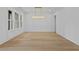 Bright dining room with hardwood floors, modern lighting and wall paneling detail at 400 Auburn Rd, Auburn, GA 30011