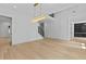 Bright dining room with hardwood floors and modern gold light fixture leading to staircase at 400 Auburn Rd, Auburn, GA 30011