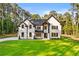 Beautiful two-story white brick home with black trim, windows and doors, and well-manicured front yard at 400 Auburn Rd, Auburn, GA 30011