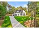 Beautiful two-story home with a long driveway, lush green lawn, and well-manicured landscaping at 400 Auburn Rd, Auburn, GA 30011