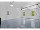 Spacious garage with epoxy flooring, bright lighting, and windows providing natural light at 400 Auburn Rd, Auburn, GA 30011