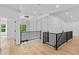 Open hallway with hardwood floors, iron railing, and stylish chandelier at 400 Auburn Rd, Auburn, GA 30011